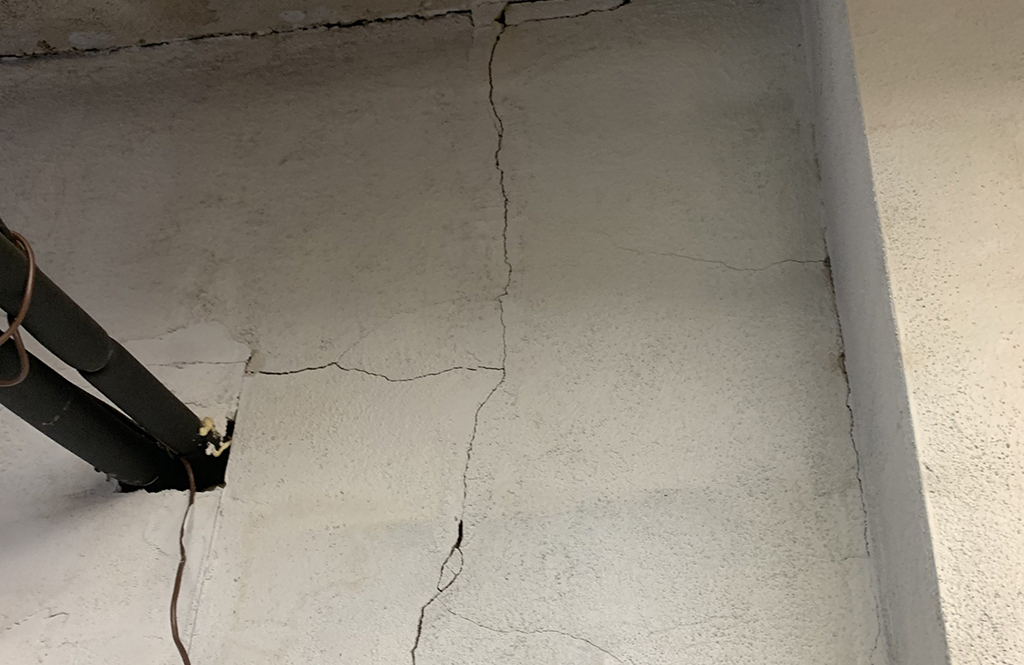 wall crack clearly visible on wall, extending from top to bottom